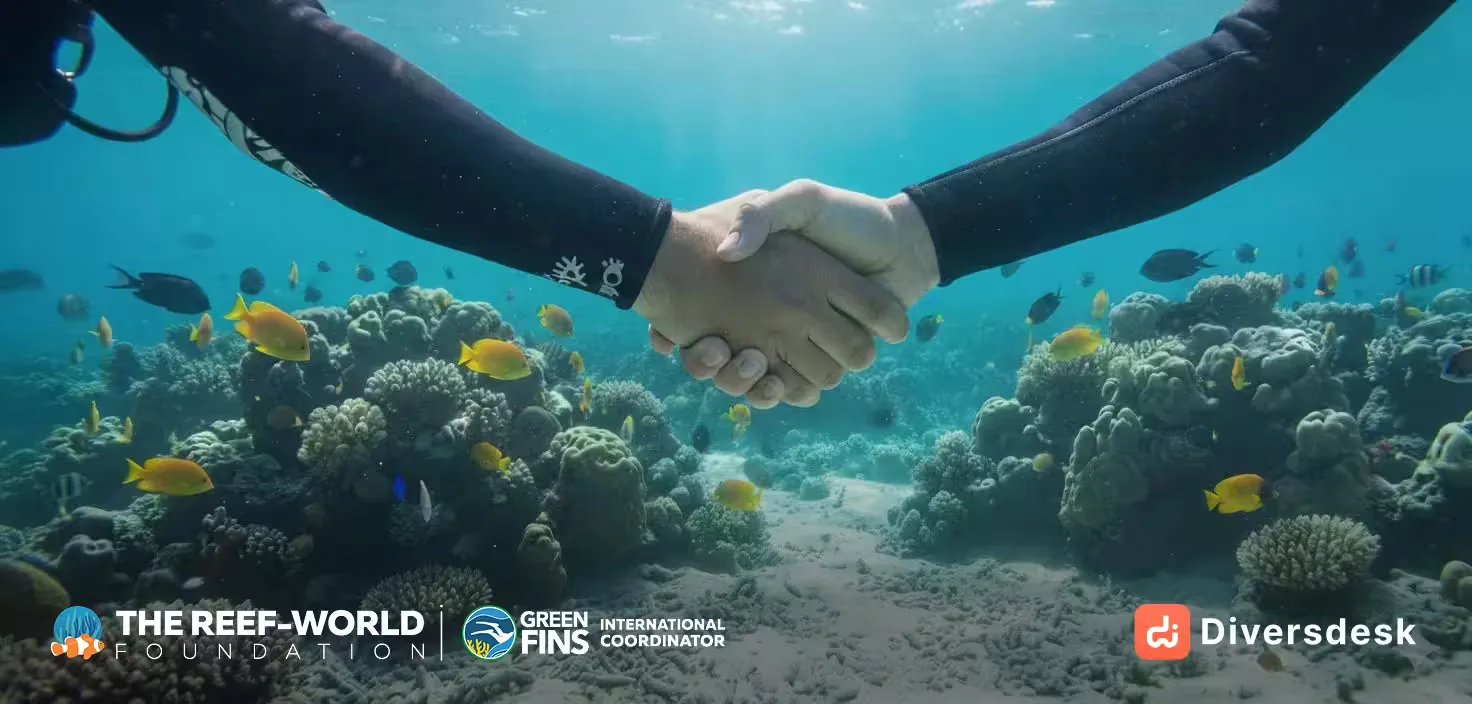 An underwater scene with a tablet showing the Diversdesk interface, representing the Green Fins partnership.