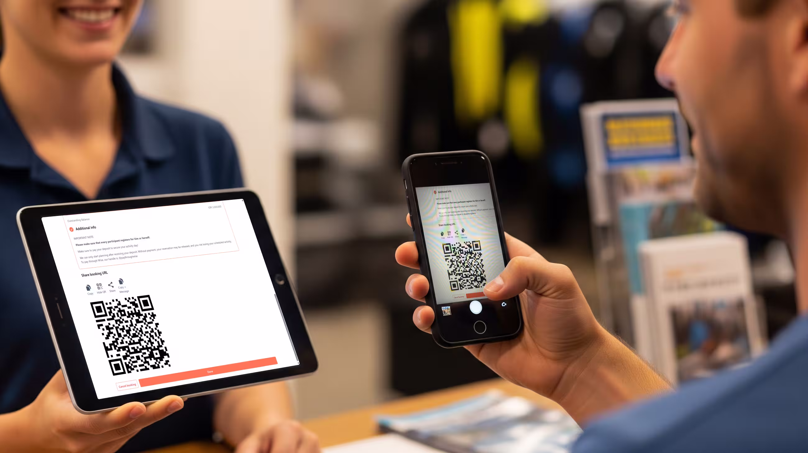A diver signing a waiver using their own mobile phone